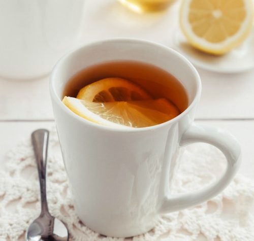 herbal tea with lemon in white ceramic cup for women's wellness and general healthy living